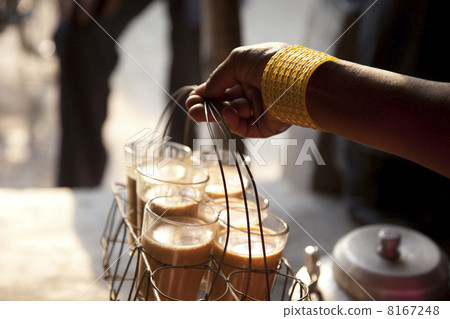 Close-up of females hand holding tray of fresh morning chai Close-up of females hand holding tray of fresh morning chai 8167248
