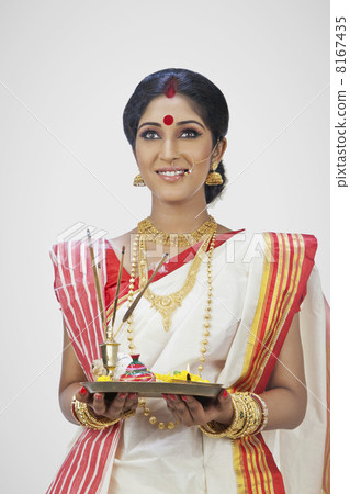 Bengali woman holding a puja thali Bengali woman holding a puja thali 8167435