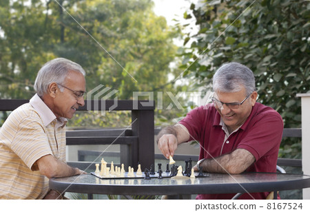 Happy senior men playing chess together 8167524