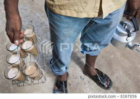 Low section of Indian street seller selling tea 8167856