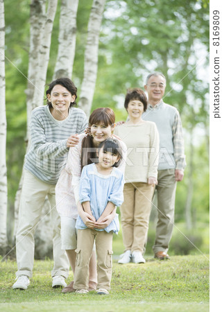 Three generations family smiling in fresh green 8169809