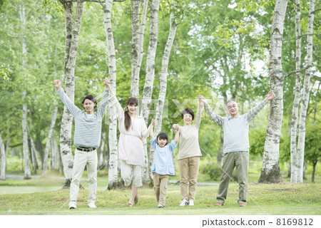 Three generations families holding hands in fresh green 8169812