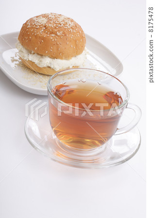 Tea cup and bun with sesame and fresh cottage cheese Tea cup and bun with sesame and fresh cottage cheese 8175478