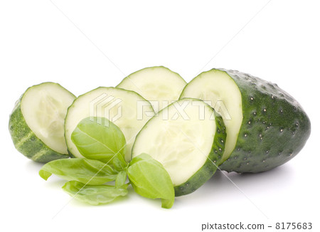 Sliced cucumber vegetable and basil leaves still life 8175683