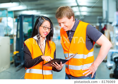 Forklift driver and supervisor at warehouse 8176069