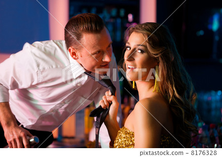 Woman dragging barkeeper in club 8176328