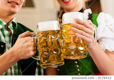 Young couple in traditional Bavarian Tracht in restaurant or pub Young couple in traditional Bavarian Tracht in restaurant or pub 8176412