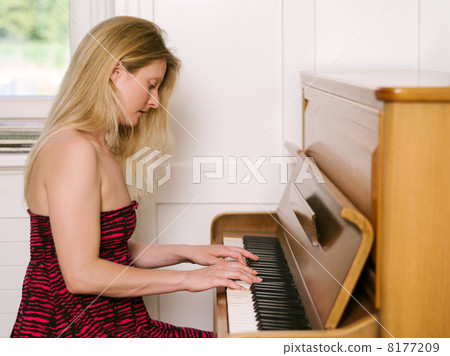 Playing an upright piano Playing an upright piano 8177209
