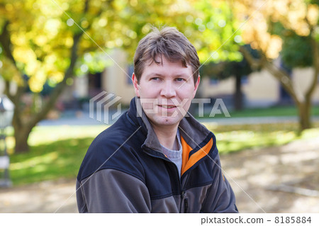 beautiful young man in park on sunny autumn day 8185884