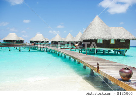 Water villas on tropical island on Maldives 8185905