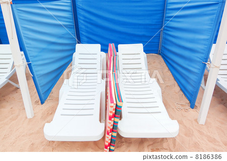 Sun loungers on the sand, and fencing for the wind. 8186386