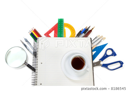 A set of office tools on the notebook for notes and a cup of cof A set of office tools on the notebook for notes and a cup of cof 8186545