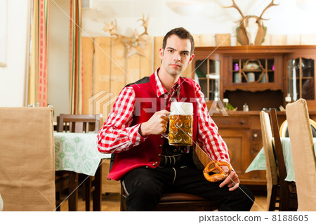 Young man in traditional Bavarian Tracht in restaurant or pub Young man in traditional Bavarian Tracht in restaurant or pub 8188605