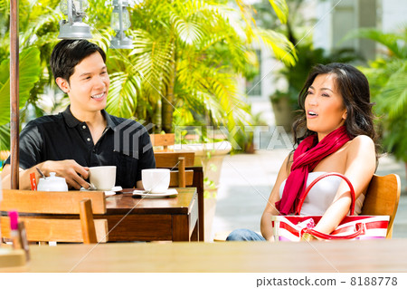 Asian man and woman in restaurant or cafe 8188778