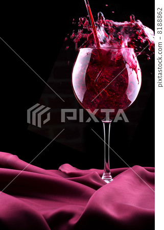 Glass of wine on red silk Glass of wine on red silk 8188862
