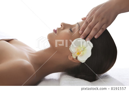 Young woman on massage table getting head massage 8191557