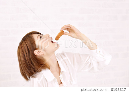 A woman eating a donut 8198817