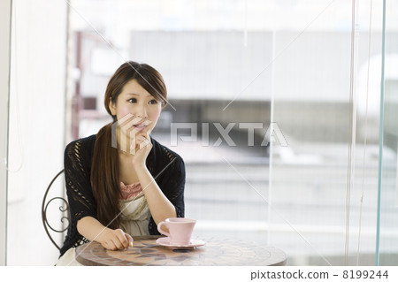 A young lady talking with his cheek on the window 8199244