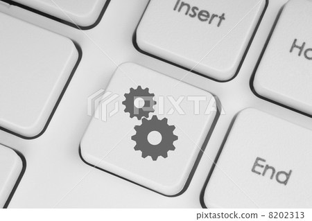 Cogwheels on white keyboard. Cogwheels on white keyboard. 8202313