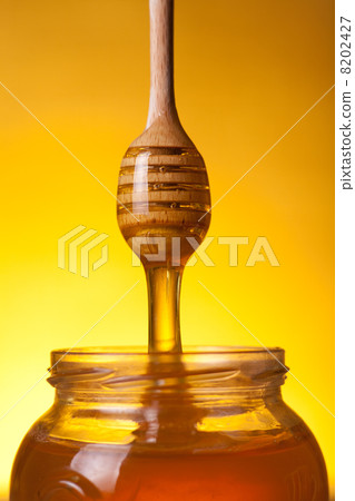 Close-up shot of flowing honey Close-up shot of flowing honey 8202427