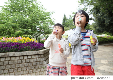 Friends brothers playing with soap bubbles Friends brothers playing with soap bubbles 8203458