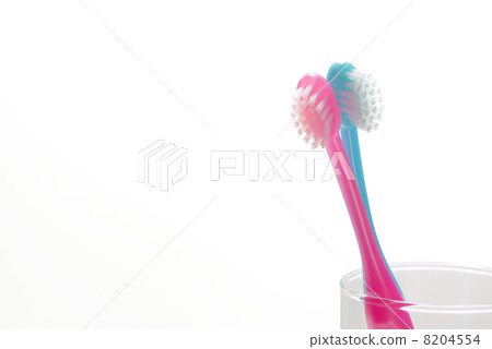 Blue and pink toothbrush in the cup 8204554