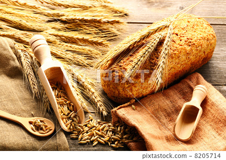 Rye spikelets and bread still life on wooden background 8205714