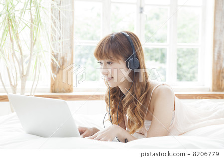 A woman relaxing in the bedroom A woman relaxing in the bedroom 8206779