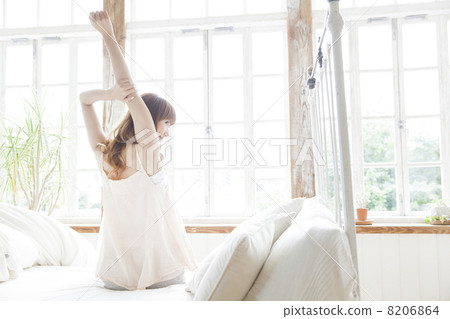 A woman relaxing in the bedroom A woman relaxing in the bedroom 8206864
