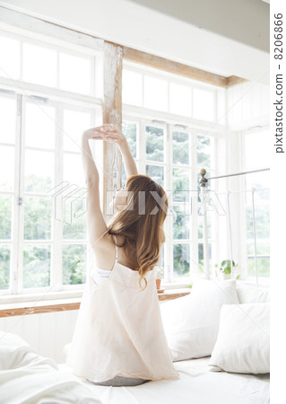 A woman relaxing in the bedroom A woman relaxing in the bedroom 8206866