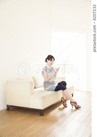 A woman relaxing on the sofa A woman relaxing on the sofa 8207232