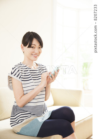 A woman relaxing on the sofa A woman relaxing on the sofa 8207233