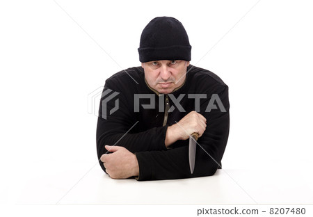 Bandit in black clothes sits and threatening with big knife 8207480
