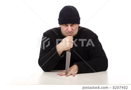 Rapist in black clothes threatens with a knife 8207482