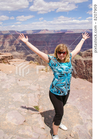 Happy woman climbing on view of Grand Canyon, USA Happy woman climbing on view of Grand Canyon, USA 8207909