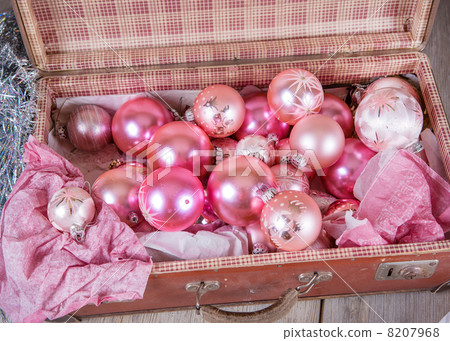 Ancient pink Christmas tree toys in antique suitcase 8207968
