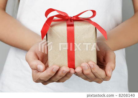 young female hands holding gift 8208140