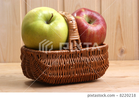 one green and one red apple in a basket 8220218