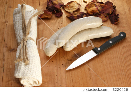 Bratwurst, sausage on an old timberboard and a knife Bratwurst, sausage on an old timberboard and a knife 8220426
