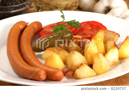 roasted potato with two home made sausages roasted potato with two home made sausages 8220737
