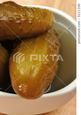 organic pickled gherkin in a white bowl 8221106
