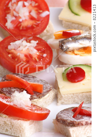 some party nibbles on a white plate 8221413