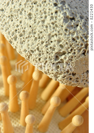 hair brush on a terry cloth towel and pumice 8221430
