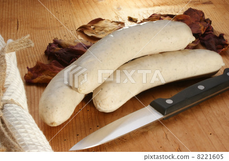 Bratwurst, sausage on an old timberboard and a knife 8221605