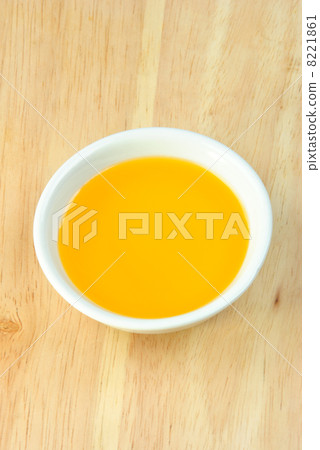organic red pepper oil in a white bowl 8221861