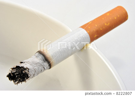 one unhealthy cigarette in a glass ashtray one unhealthy cigarette in a glass ashtray 8222807