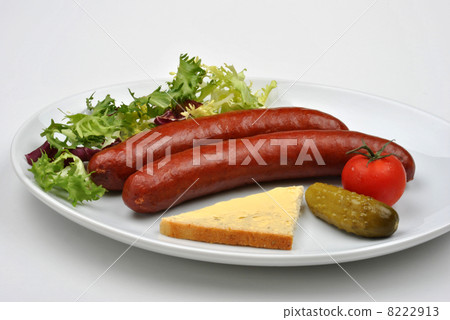 smoked sausage and organic gherkin on a plate smoked sausage and organic gherkin on a plate 8222913