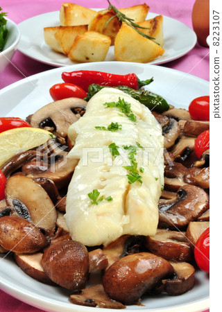 cod loins with organic mushroom on a plate 8223107