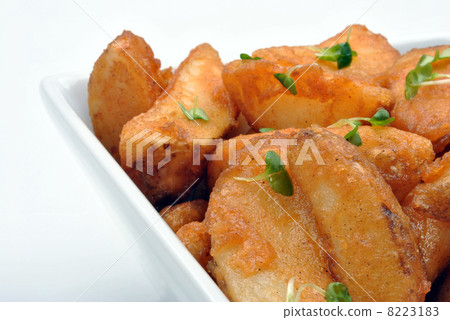 some fried potato wedges in a bowl 8223183