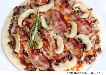 Pizza with bacon and mushrooms on a plate 8223211